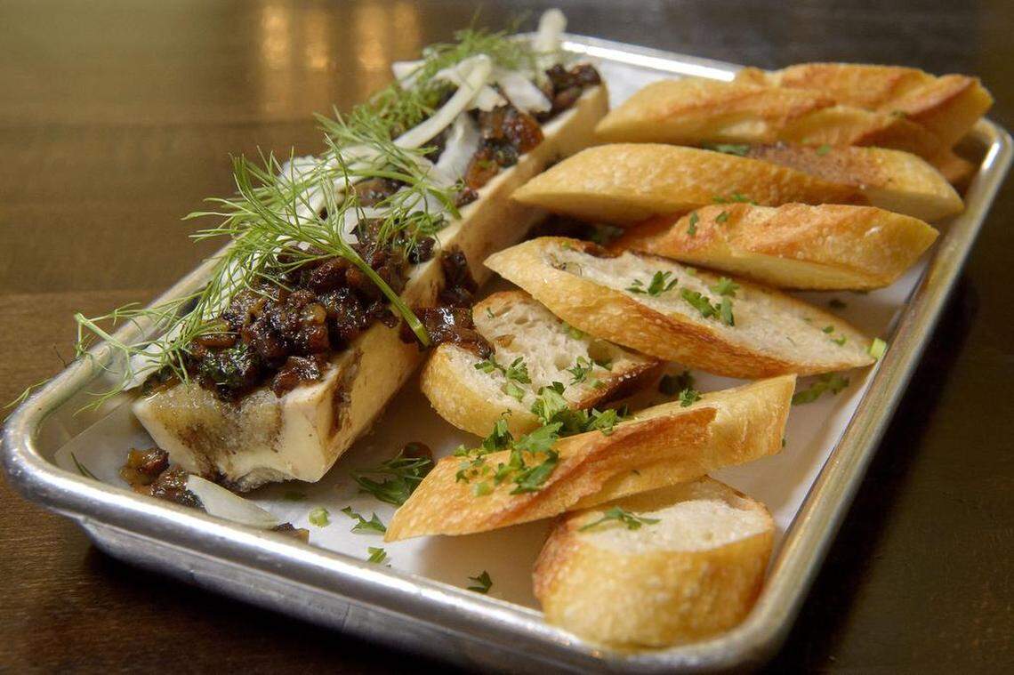 The bone marrow topped with bacon jam and organic citrus fennel served with grilled sourdough baguette at Backbone Café.
