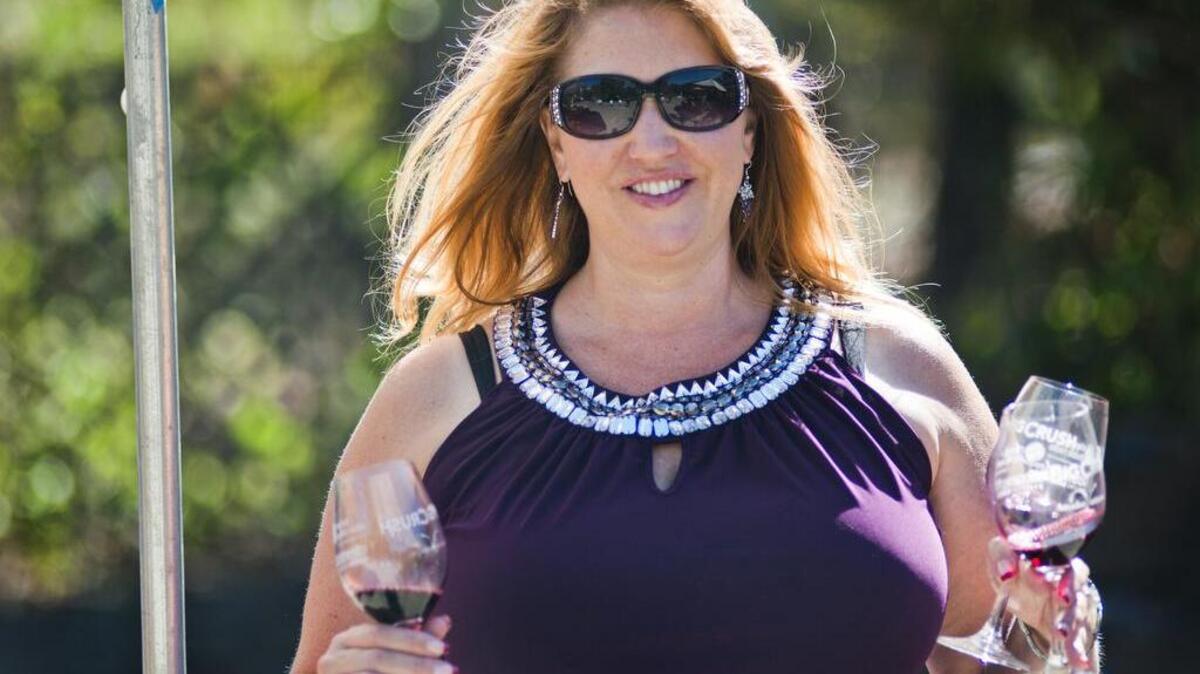 
Karen Hyatt-Miner of Reno brings wines back to a group of friends during the Big Crush Harvest Festival, a celebration of Amador County wines, on Saturday Oct. 3, 2015.
