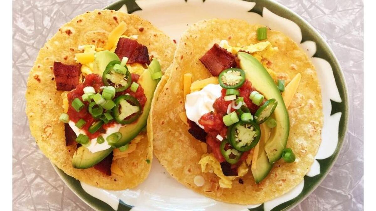 I have a small flock of hens here in Curtis Park, and when you have the availability of fresh-laid eggs, you get creative with breakfast. Sunday’s breakfast was breakfast tacos: soft tortillas filled with perfectly scrambled eggs, crispy bacon, sharp cheddar cheese, avocado slices, salsa, sour cream, green onions and jalapeño slices.
