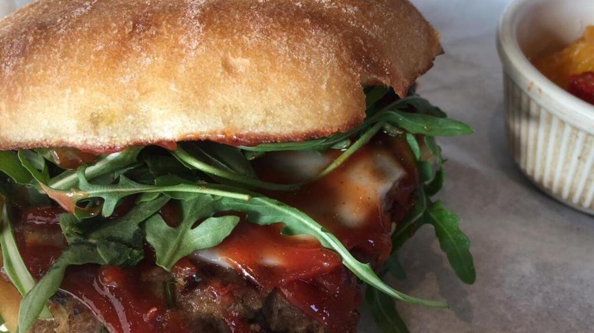 The meatloaf sandwich at Skip’s Kitchen is topped with cumin-spiked ketchup, provolone and arugula.