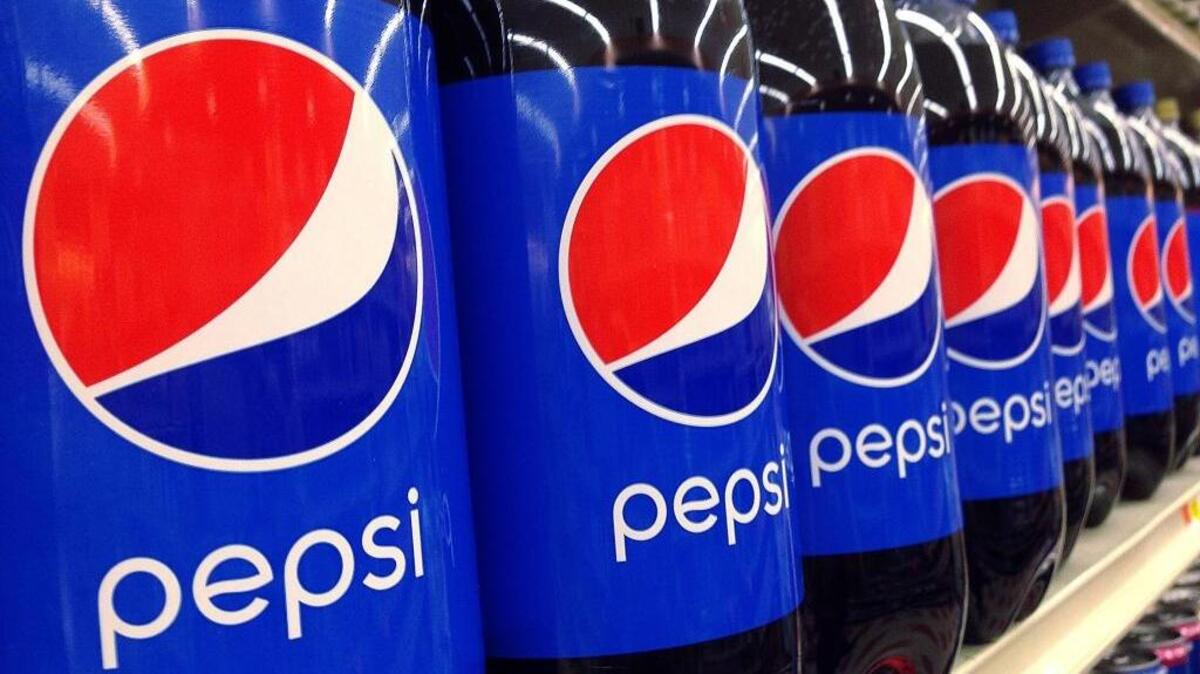 FILE - In this July 9, 2015, file photo, Pepsi bottles are on display at a supermarket in Haverhill, Mass. PepsiCo Inc. reports earnings, Wednesday, April 26, 2017. Pepsi’s new “Fire” flavor will be released nationwide on Monday, May 22, 2017.