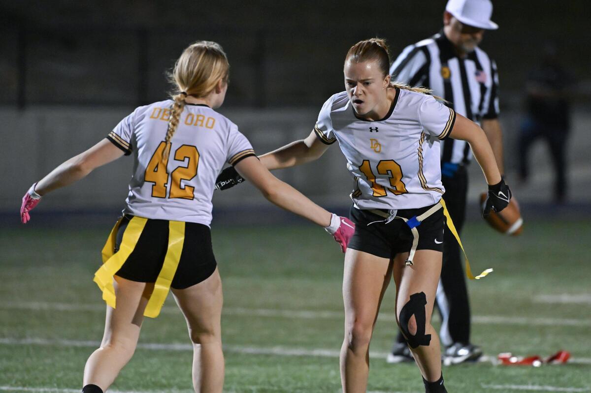 The Del Oro Golden Eagles’ Izzy Scott (13) celebrates with teammate Cali Boehrer (42) after sacking the quarterback in the second half of the CIF Sac-Joaquin Division I flag football championship on Saturday, Nov. 4, 2023, at Cosumnes River College in Sacramento.
