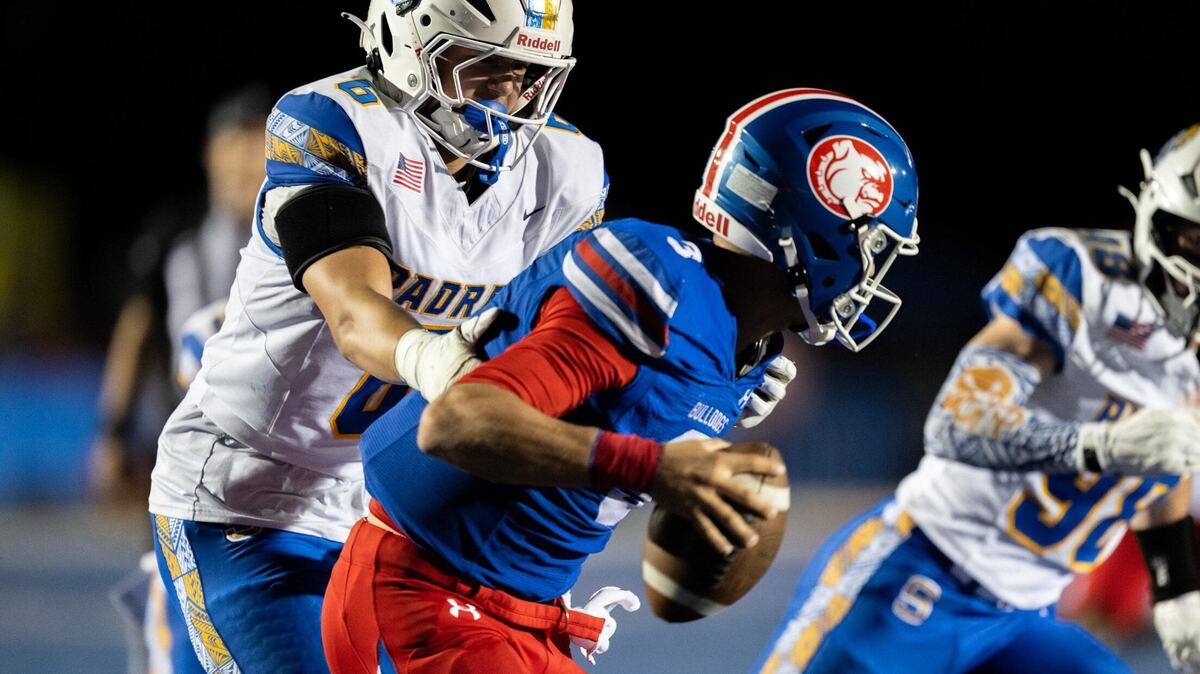 Serra Padres lineman Tommy Miller (6) grabs Folsom Bulldogs quarterback Ryder Lyons (3) on Friday at Folsom High School. Serra defeated the Bulldogs, 22-21.