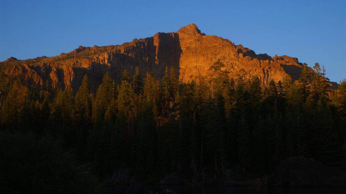 Evening light illuminates the summit of Thunder Mountain in 2004 above the Eldorado National Forest’s Silver Lake.