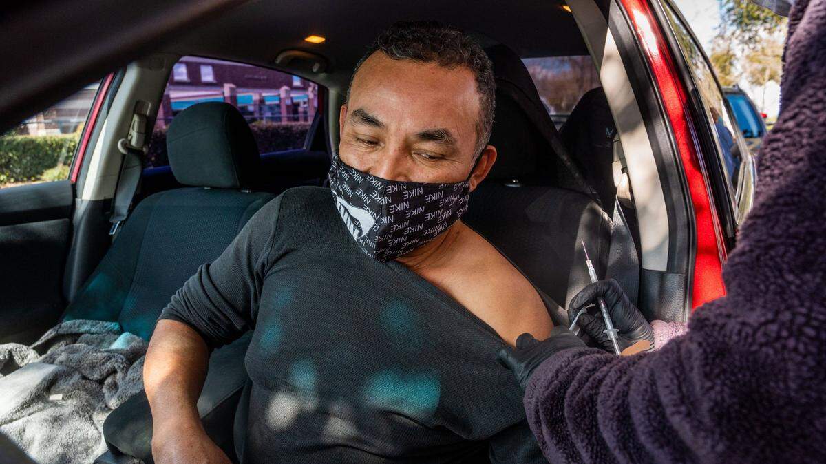 Juan Antonio Garcia, 45, a restaurant worker, gets his Pfizer COVID-19 vaccine at Natomas High School in Sacramento on Thursday, March 11, 2021.