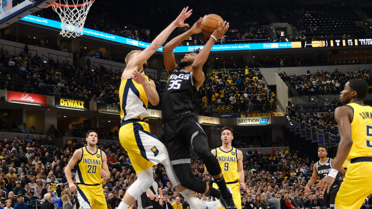 Sacramento Kings forward Marvin Bagley III (35) shoots over Indiana Pacers forward Domantas Sabonis during the first half of an NBA basketball game in Indianapolis, Friday, Dec. 20, 2019. (AP Photo/AJ Mast)