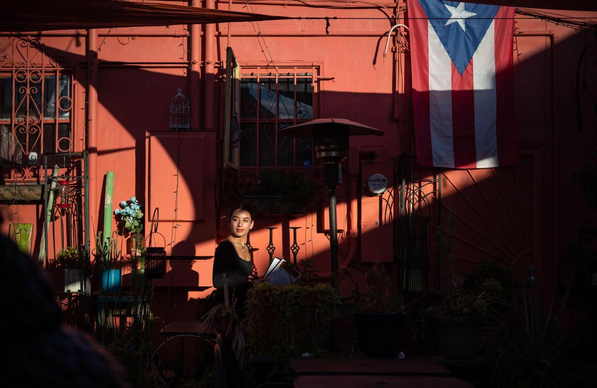 Manger and co-owner Lola Serrano looks back over the outside patio dining area after taking an order at Lola’s Lounge on 16th Street near Broadway in Sacramento. Her mother, owner Annette Serrano, named the Puerto Rican cuisine restaurant after her when they opened in Elk Grove.