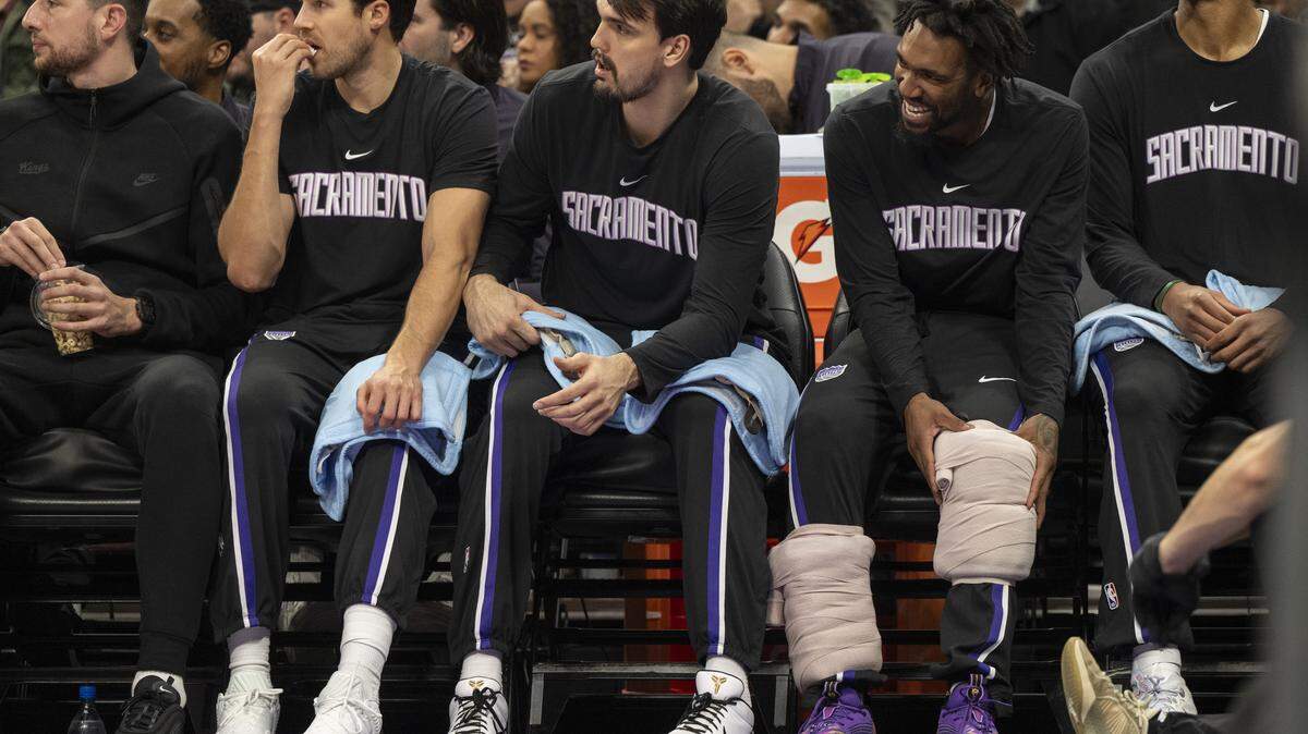 Sacramento Kings guard Malik Monk, right, sits on the bench during a game at Golden 1 Center in Sacramento on Sunday.