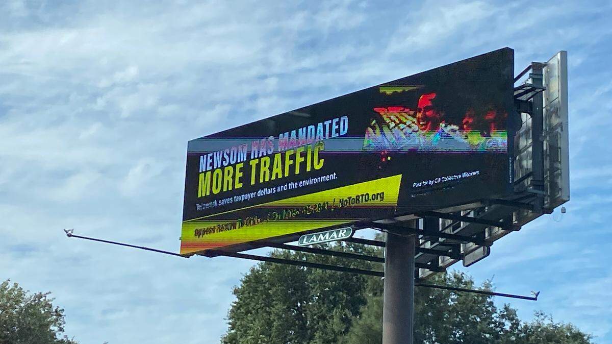 A billboard criticizing Gov. Gavin Newsom’s decision to call workers back to state offices seen driving north on Business I-80 on July 3, 2025.