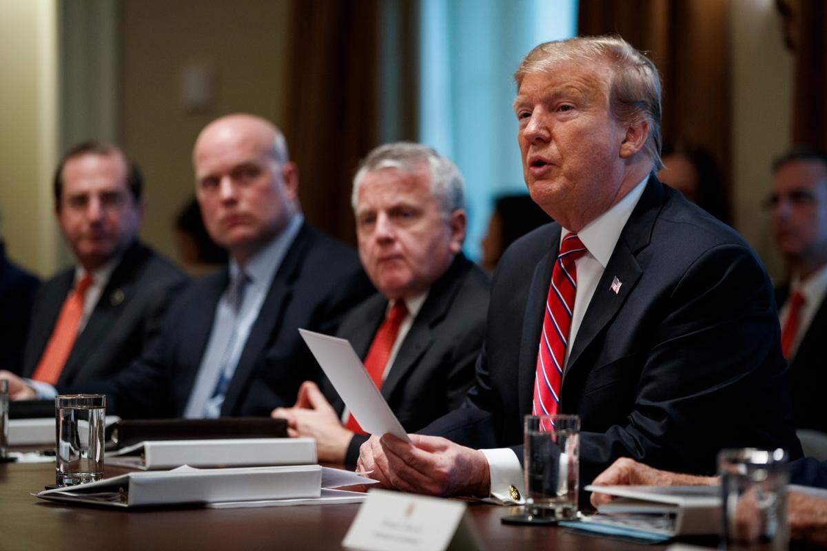 President Donald Trump speaks during a cabinet meeting at the White House, Tuesday, Feb. 12, 2019, in Washington. From left, Secretary of Health and Human Services Alex Azar, acting Attorney General Matthew Whitaker, Deputy Secretary of State John Sullivan, and Trump. (AP Photo/ Evan Vucci)