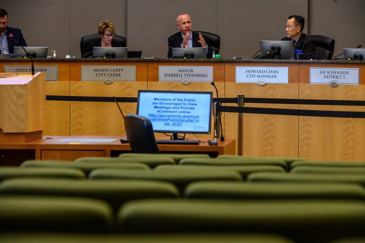 Sacramento Mayor Darrell Steinberg and the rest of the City Council meet on Friday, March 13, 2020, with physical attendance limited to the media as the coronavirus shutdown begins. The council considered emergency measures to help residents and businesses affected by the pandemic, as a message on computer monitor asks members of the public to view meetings and provide eComments online.