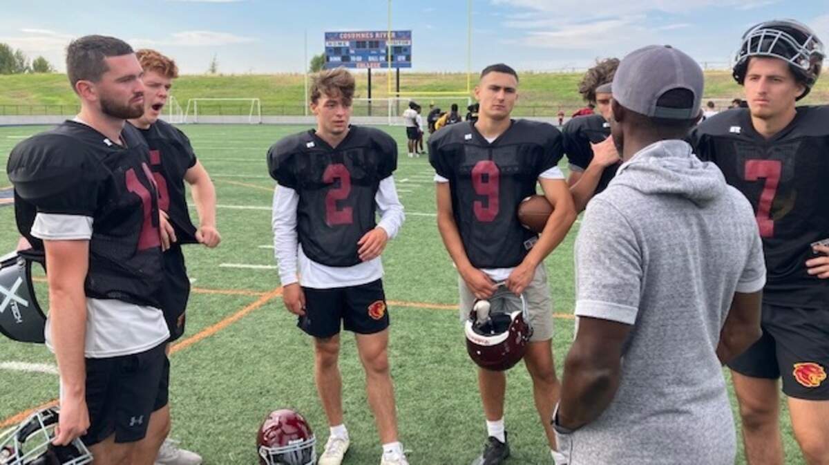 Sacramento City College coach Dannie Walker talks to a group of players as his team prepares to host American River College at 1 p.m. Saturday at Hughes Stadium.