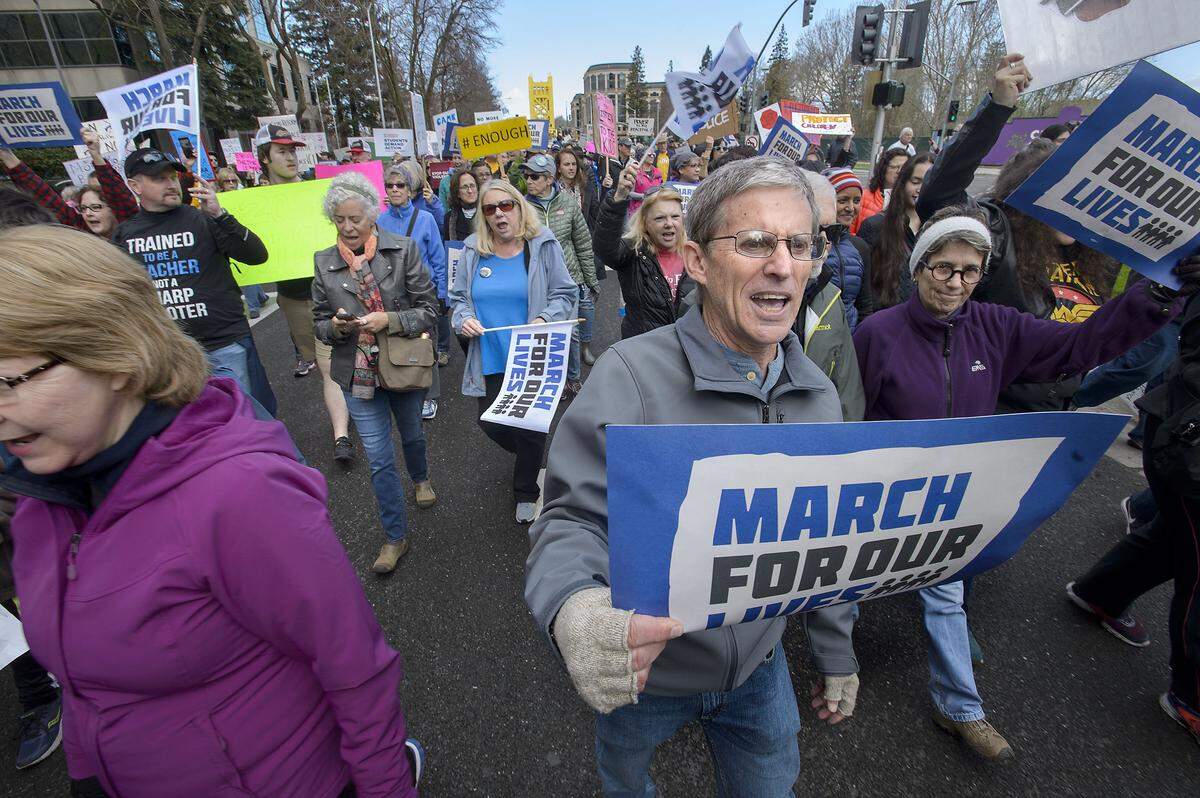 Demonstrators, including John McBath of Cameron Park, right, march up Capitol Mall during the “March For Our Lives” demonstration Saturday in Sacramento.