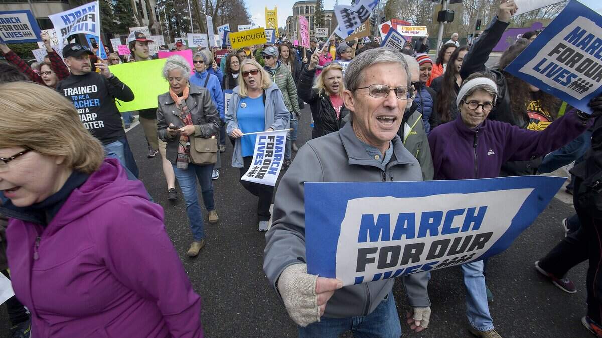 Demonstrators, including John McBath of Cameron Park, right, march up Capitol Mall during the “March For Our Lives” demonstration Saturday in Sacramento.