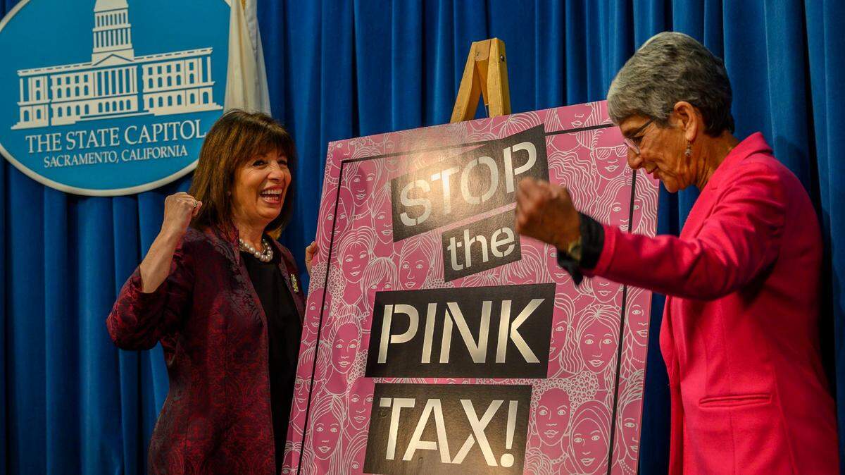 Congresswoman Jackie Speier, D-Hillsborough, left, and state Senator Hannah-Beth Jackson, D-Santa Barbara, right, hold up fists after a press conference advocating the end to the so-called “pink tax,” where womens products are priced higher than the same products marketed to men, at the California State Capitol in Sacramento on Tuesday, Feb. 18, 2020. Senate Bill 873 would make it illegal to charge customers different prices on the basis of gender for substantially similar goods.