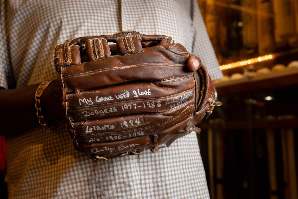 Dusty Baker wears the baseball glove he used during his playing career with the Los Angeles Dodgers, San Francisco Giants and Oakland Athletics at his home in Granite Bay on Wednesday.