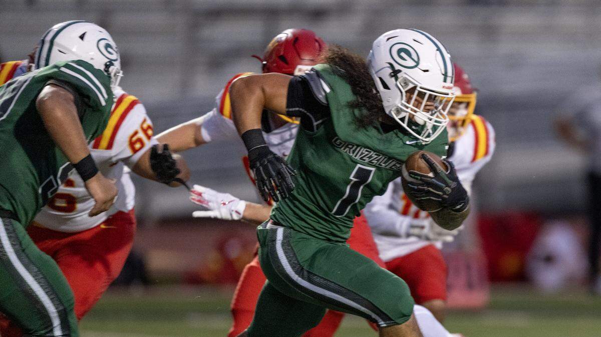 The Granite Bay Grizzlies' Isaiah Ene (1) runs through the Jesuit Marauders' defense on Friday in Granite Bay.