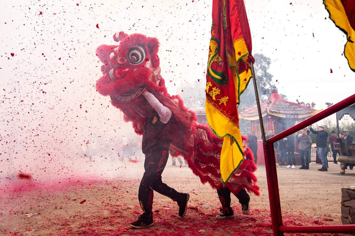 Firecrackers and smoke fill the air during the traditional Chinese lion dance at the Sacramento Chinese Of Indochina Friendship Association’s annual Lunar New Year celebration at the temple on Elder Creek Road on Saturday, Jan. 25, 2020, in Sacramento.