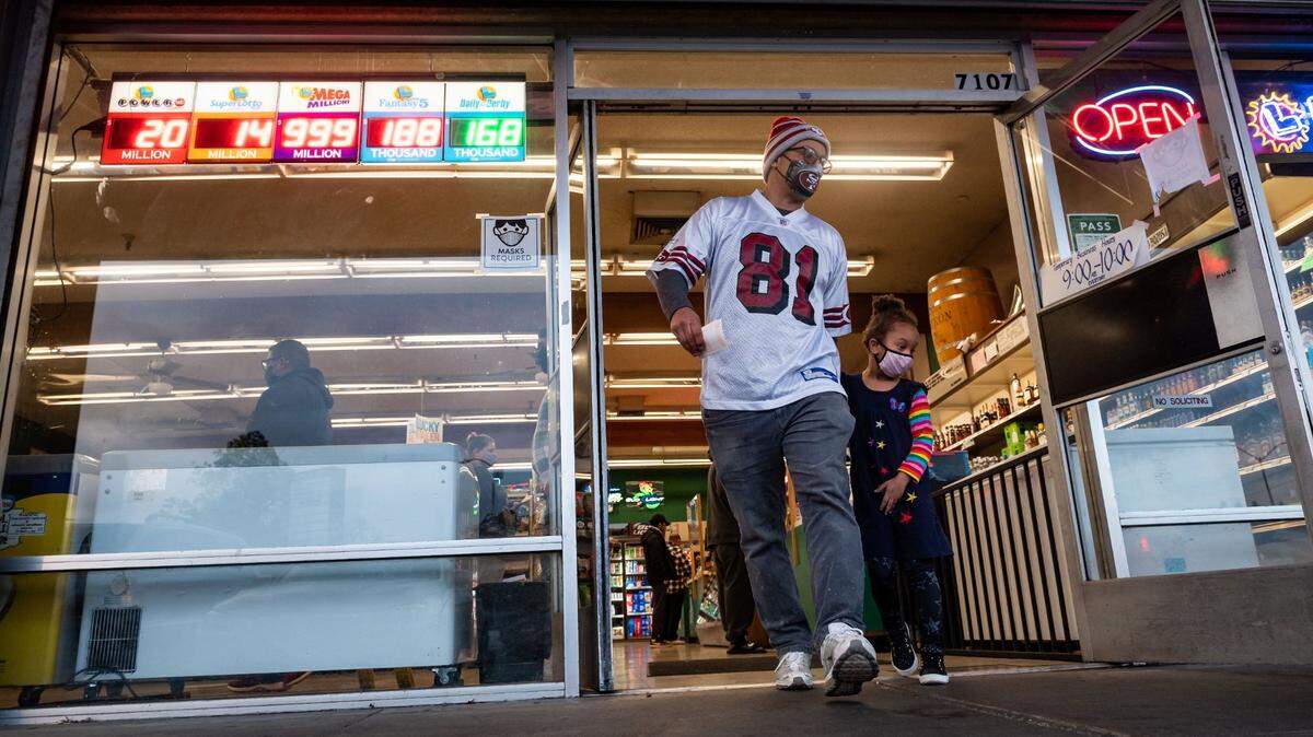 A man leaves a Sacramento store after buying lottery tickets in January.