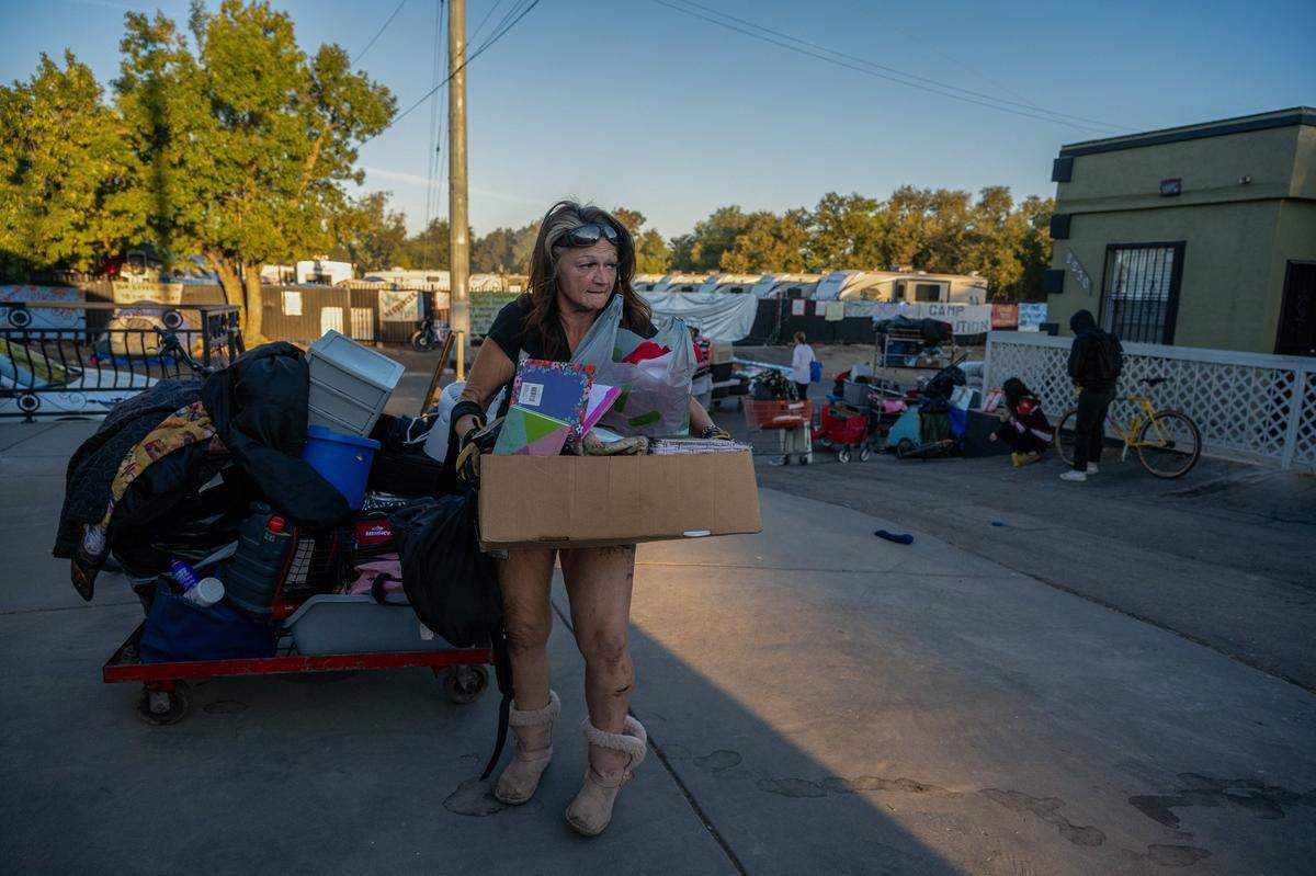 Jeanne Gillis, 53, who suffered a seizure yesterday from stress at her storage unit, scrambles to place the rest of her belongings in a U-Haul before Sacramento Police arrive to remove Camp Resolution on Monday.