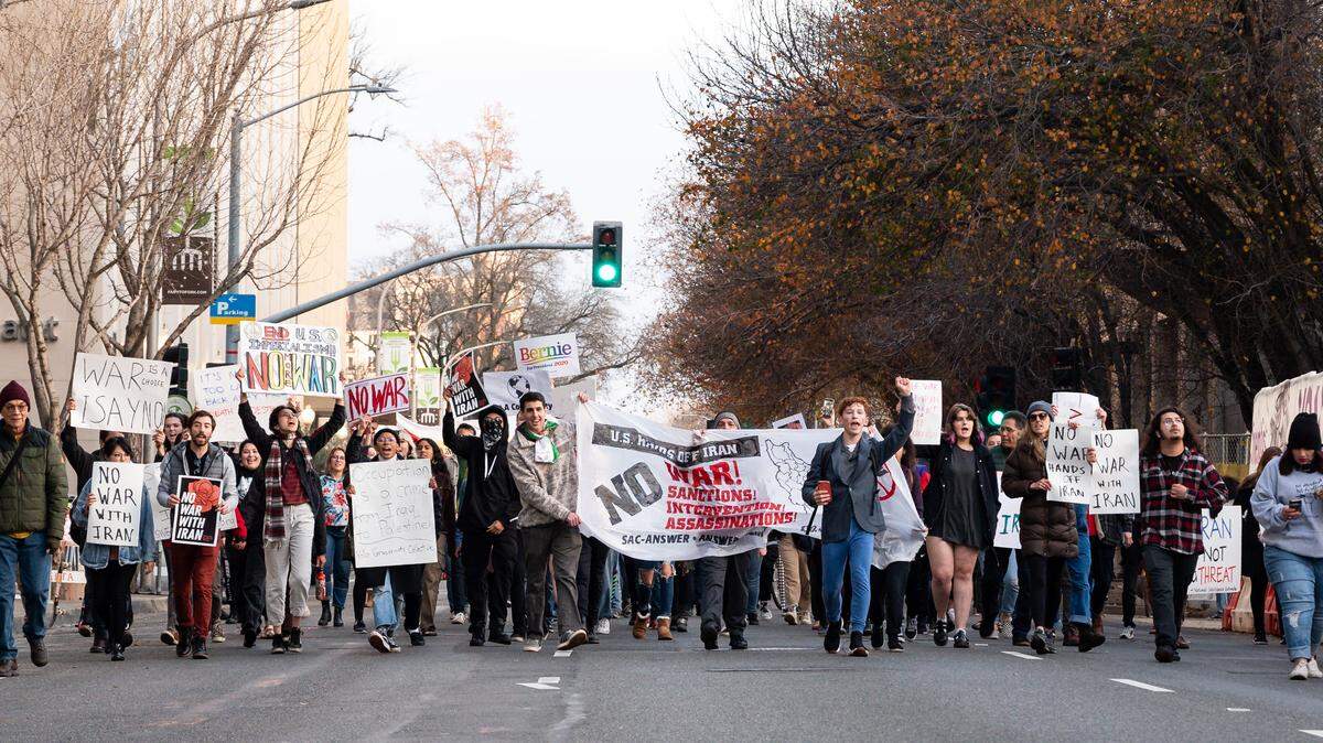 People protest military actions in Iran — and the Middle East in general — as they march west on J Street on Saturday, Jan. 4, 2020, in downtown Sacramento.