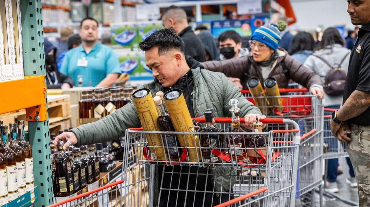 Barry Thepvong, of Fresno, looks at whisky bottles during the grand opening of the Natomas Costco store on Thursday, March 14, 2024.