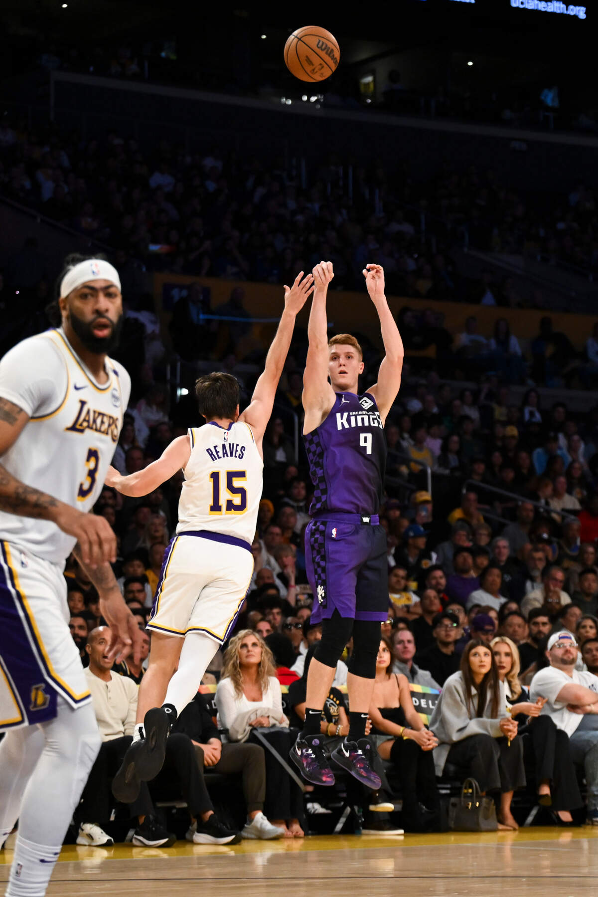 Sacramento Kings guard Kevin Huerter (9) shoots against Los Angeles Lakers guard Austin Reaves (15) during the first half Saturday, Oct. 26, 2024, at Crypto.com Arena in Los Angeles.