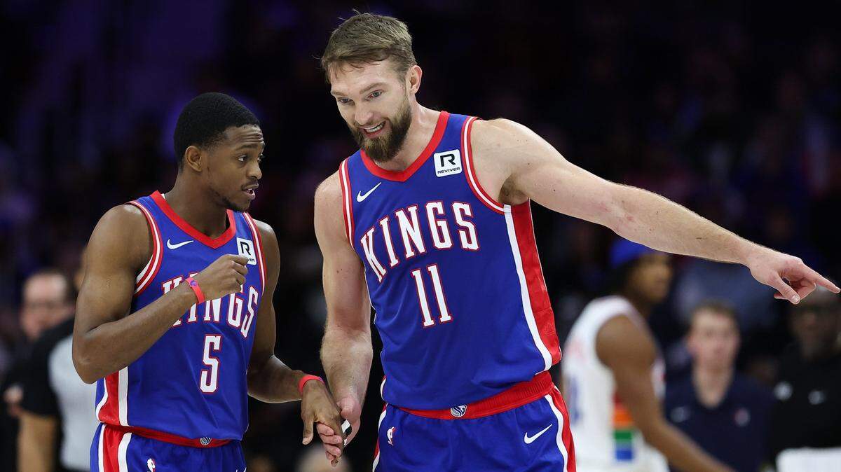 Jan 29, 2025; Philadelphia, Pennsylvania, USA; Sacramento Kings guard De'Aaron Fox (5) and forward Domantas Sabonis (11) talk during the second quarter against the Philadelphia 76ers at Wells Fargo Center. Mandatory Credit: Bill Streicher-Imagn Images