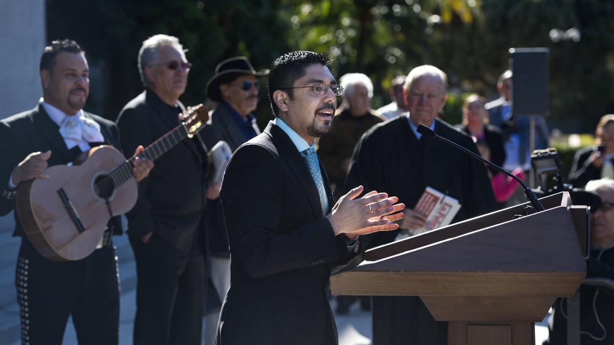 Sergio Garcia, an undocumented immigrant from Mexico, talks to supporters after he was sworn in to practice law in California by then-state Supreme Court Associate Justice Cruz Reynoso in 2014.