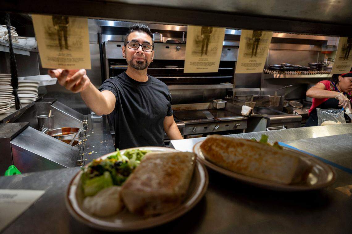 Ulysses Unzueta fills orders in the kitchen at Caballo Blanco restaurant on Friday.