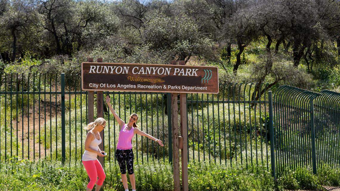 Australian tourists Kaz Hollingsworth, left, and Libby Hunter stand outside Runyon Canyon Park in Los Angeles in 2016. A woman who ended up stranded on a steep trail in the canyon was rescued Friday with a rope system, California firefighters said.