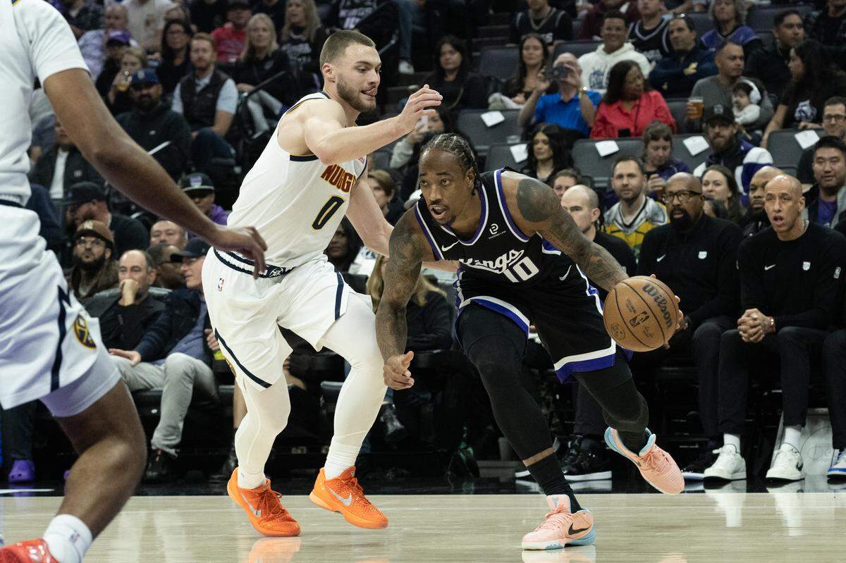 Sacramento Kings guard DeMar DeRozan (10) drives against Denver Nuggets guard Christian Braun (0) during a game at the Golden 1 Center on Tuesday, Nov. 11, 2025, in Sacramento. 