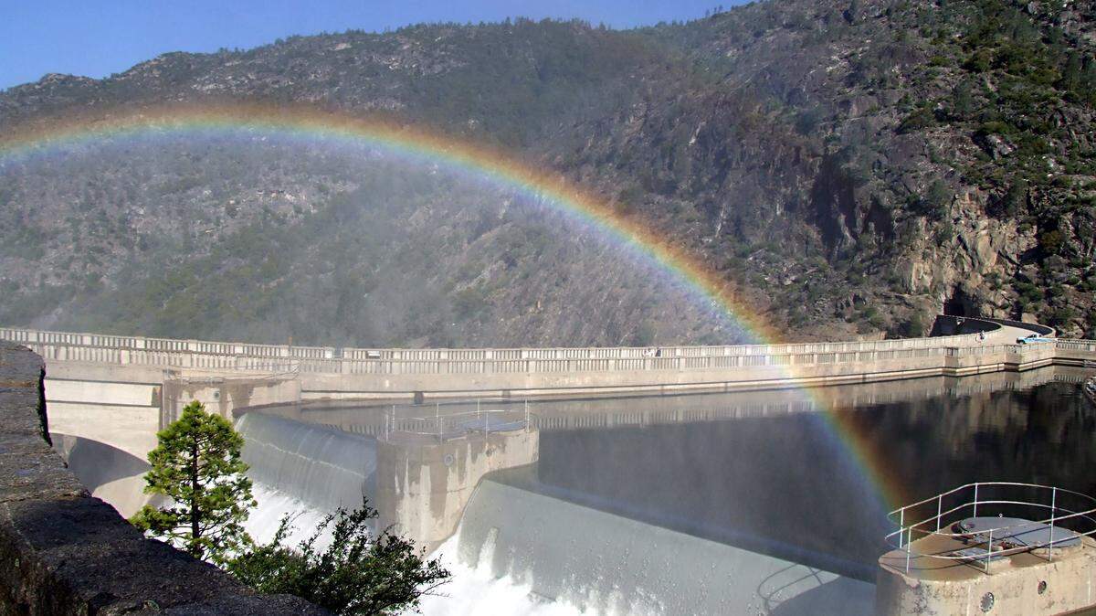 A rainbow forms in the mist from water releases at Hetch Hetchy Reservoir. The city of San Francisco, which owns Hetch Hetchy, is backing a state plan that would leave more water in the rivers at the city’s expense.
