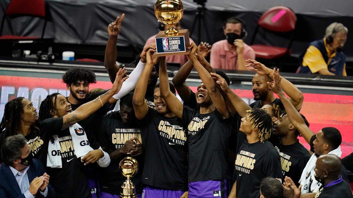 Sacramento Kings players hold up the trophy after defeating the Boston Celtics in the NBA summer league championship basketball game Tuesday, Aug. 17, 2021, in Las Vegas. (AP Photo/John Locher)