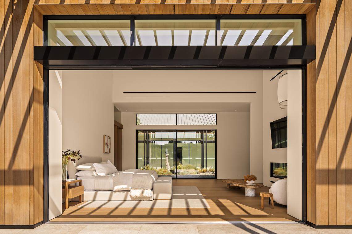 Newly built with four years of masterful design, this single-story architectural farmhouse features grand spaces, glass walls, and 12-20 foot ceilings throughout.