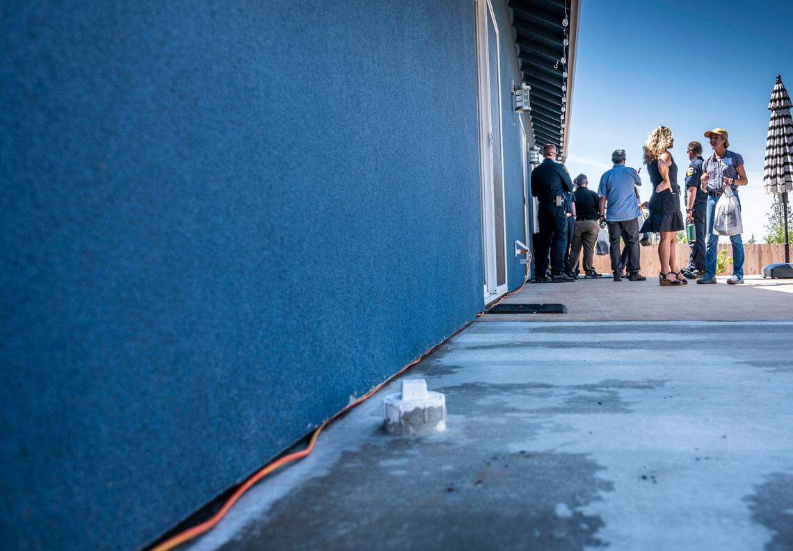 Paradise resident Casey Taylor welcomes visitors to her home on Wednesday, the day her property received the nation’s first Wildfire Prepared Home designation. The house was built with fire-resistant materials, including a concrete porch and stucco walls.
