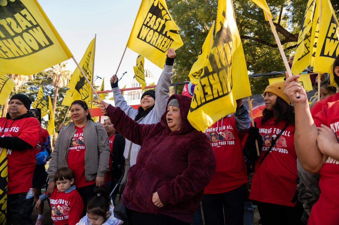 Sandra Jauregui, center, a fast-food worker for 14 years, and other workers in the industry rally at the state Capitol in Sacramento in November, demanding that fast-food companies such as McDonald’s, In-N-Out Burger and Chipotle stop seeking to repeal Assembly Bill 257, which creates a government-run labor council for the industry.