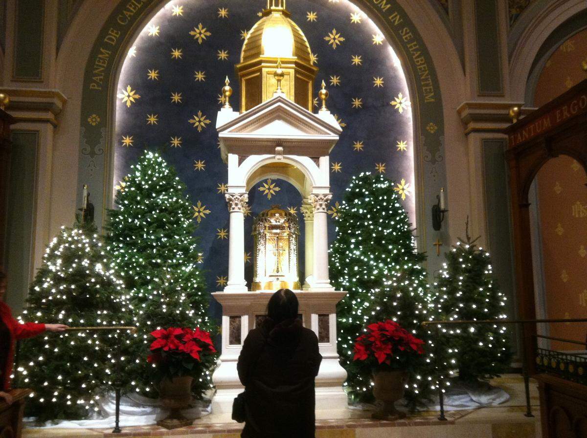 A person looks up at the holiday decor during Midnight Mass at the Cathedral of the Blessed Sacramento in 2012.
