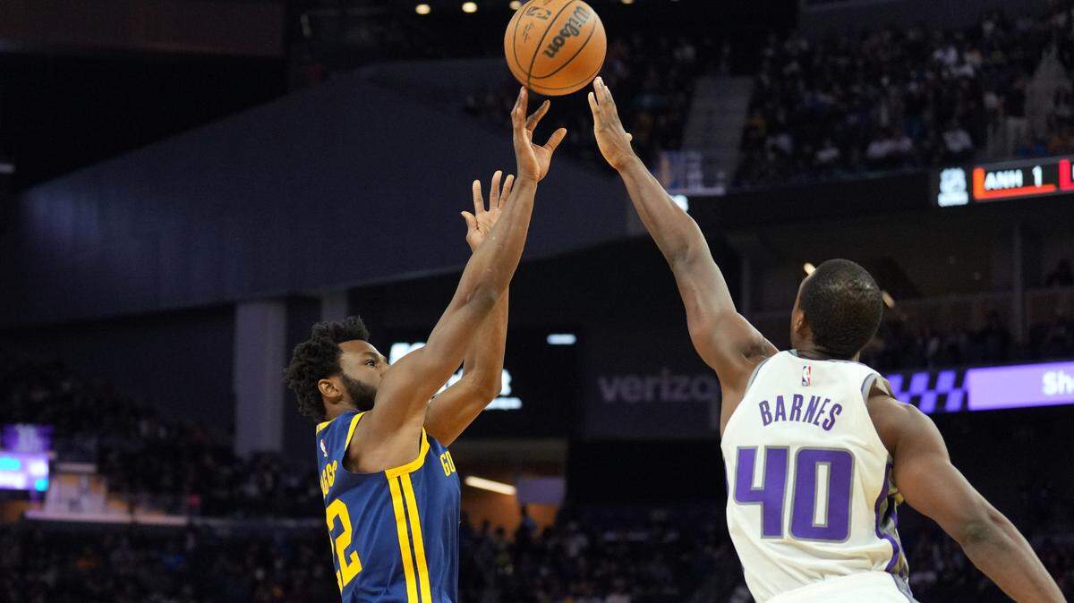 Golden State Warriors forward Andrew Wiggins (22) shoots against Sacramento Kings forward Harrison Barnes (40) during the third quarter at Chase Center on Oct. 23 in San Francisco.