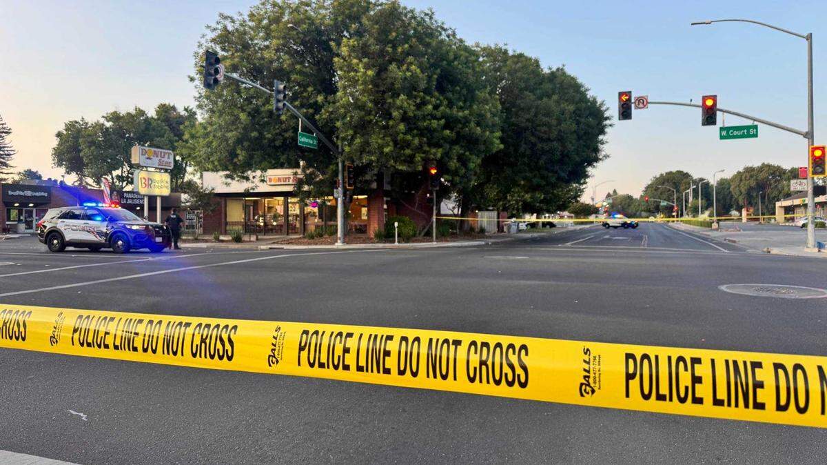 Police investigate the scene of a reported stabbing Monday, June 16, 2025, near the intersection of California and West Court streets in Woodland. A man was hospitalized with serious injuries, authorities said, and a 49-year-old man was arrested and charged with attempted murder.
