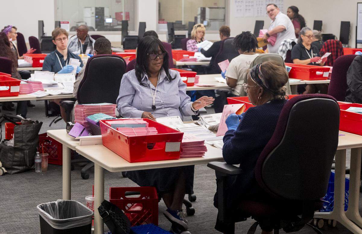 Workers at the Sacramento County Voter Registration and Elections building extract ballots from their envelopes after verification and prepare the ballots for tabulation in Sacramento on Tuesday, June 2, 2026. The workers check the ballots for any markings or rips that might affect the ballots from being run through the tabulators.