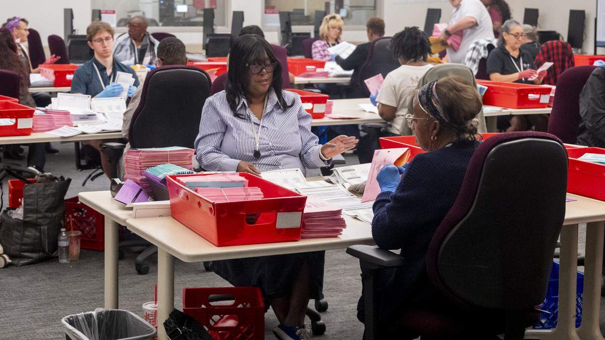 Workers at the Sacramento County Voter Registration and Elections building extract ballots from their envelopes after verification and prepare the ballots for tabulation in Sacramento on Tuesday, June 2, 2026. The workers check the ballots for any markings or rips that might affect the ballots from being run through the tabulators.
