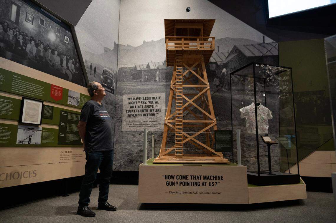 Stan Umeda stands earlier this month next to a replica he built of a guard tower used at the ten incarceration camps during World War II at the new “Uprooted: An American Story” exhibition inside of the California Museum in Sacramento. “I’ve always wanted to make one because that was what camp represented to me, guard towers and barbed wire,” he said.