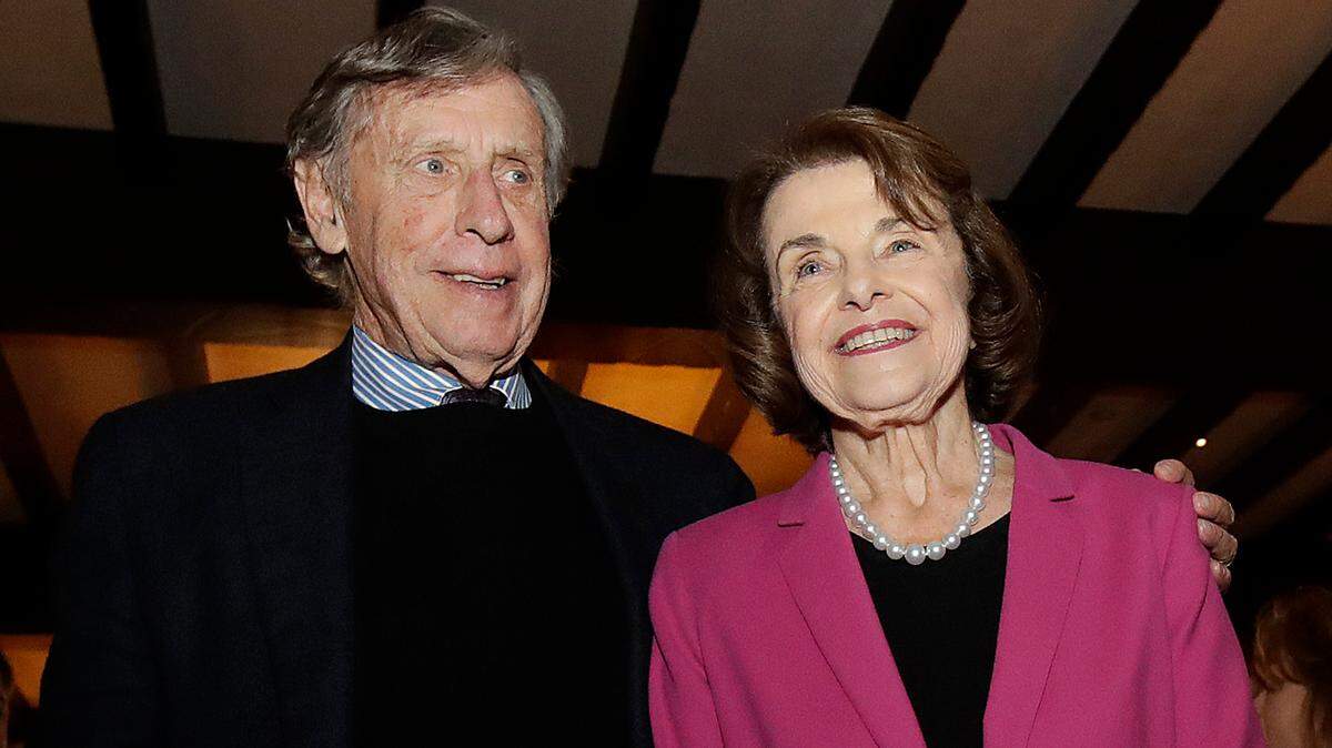 FILE - In this Nov. 6, 2018, file photo, U.S. Sen. Dianne Feinstein, right, smiles next to husband Richard Blum at an election night event in San Francisco. Bloom died Sunday night.