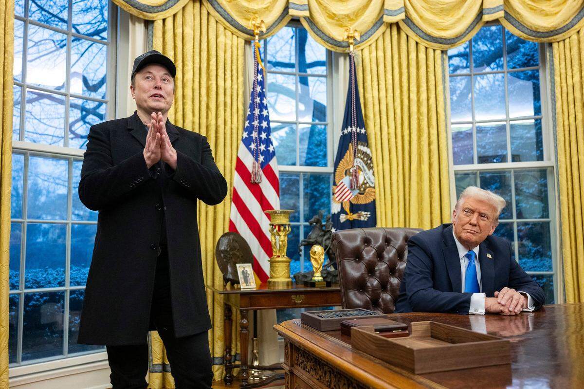Elon Musk speaks as President Donald Trump looks on in the Oval Office of the White House in Washington, D.C., on Feb. 11.