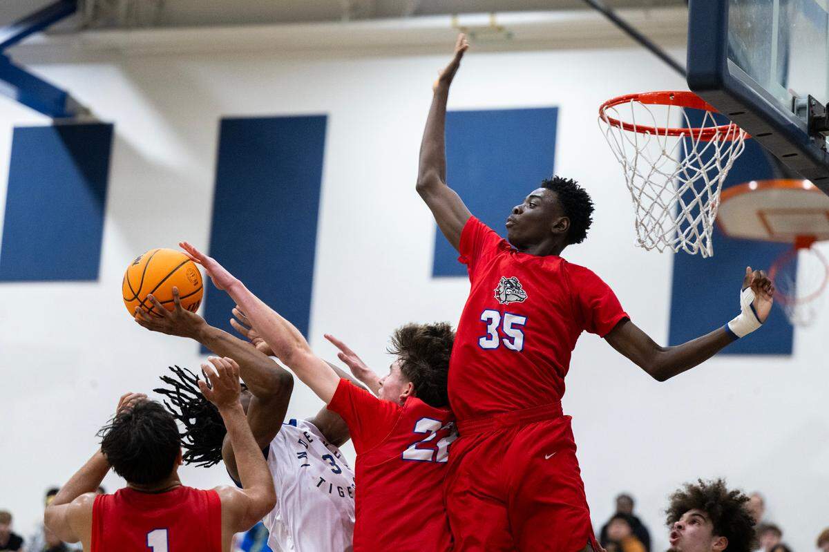 The Folsom Bulldogs’ Siyahe Siaisiai (35) goes up to block the shot of the Inderkum Tigers’ Siincere Hudson (3) as Folsom's Joven Dulay (1) and Jack Shull (22) defend in the second half on Tuesday.