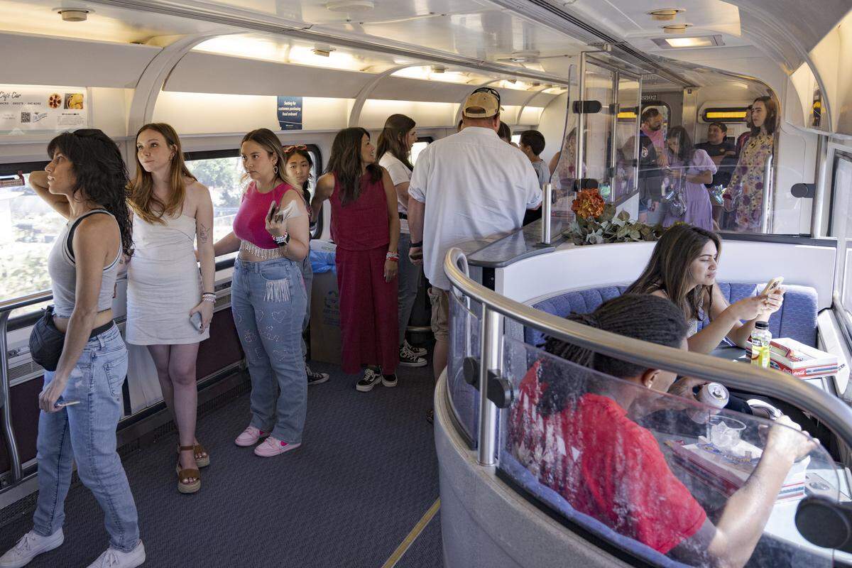 People wait in line for food and drinks on July 28, 2023, during the three-hour train trip from Sacramento to Levi's Stadium for the Taylor Swift concert.