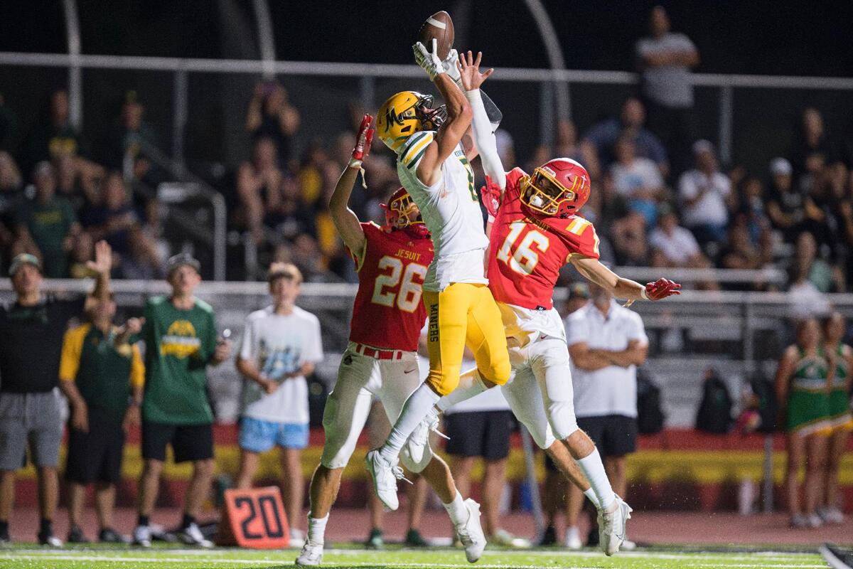 Jesuit Marauders safety Caleb Dixon (26) and cornerback Jack Payant (16) break up a pass intended for Bishop Manogue wide receiver Ben Scolari (8) during the second half of the high school football game at Jesuit High School on Friday, Aug. 25, 2023, in Carmichael.
