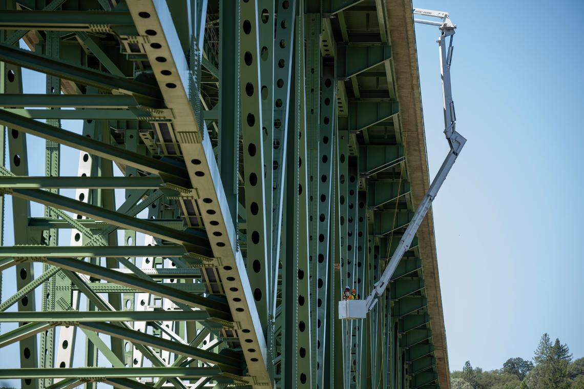 A snooper truck uses its use long mechanical arms to lower a bridge inspector below the roadway of the Foresthill Bridge on Wednesday near Auburn. The inspector will use ultrasonic testing to assess 282 welds on the 730-foot-tall structure.