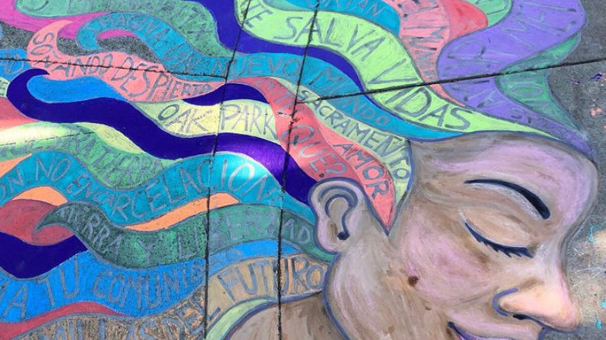 As part of the Imagine a New World project in Oak Park, Yoly Petra Stroeve’s chalk mural features a woman with rainbow hair, each strand holding a different Spanish word or phrase.